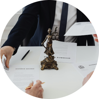 Attorney signing legal documents with Lady Justice statue